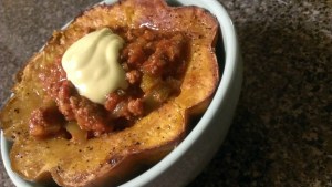 Chili in roasted acorn squash cup with avocado cream 
